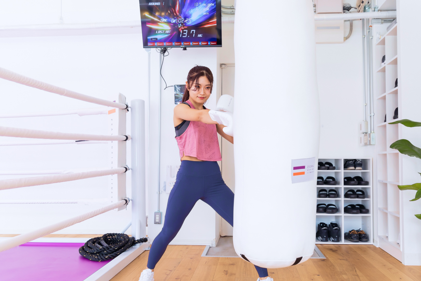 白いサンドバッグを打つ女性